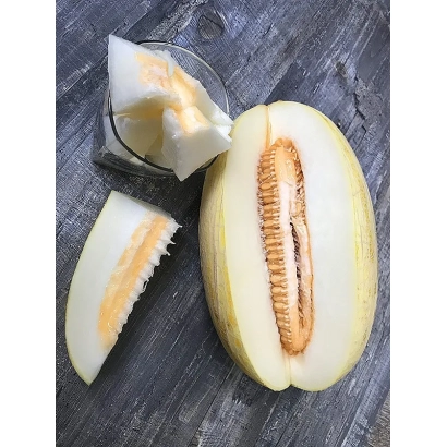 Sliced melon with visible core and seeds on a wooden surface - Torpeda