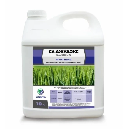 Jug of fungicide SA Judoks on green background