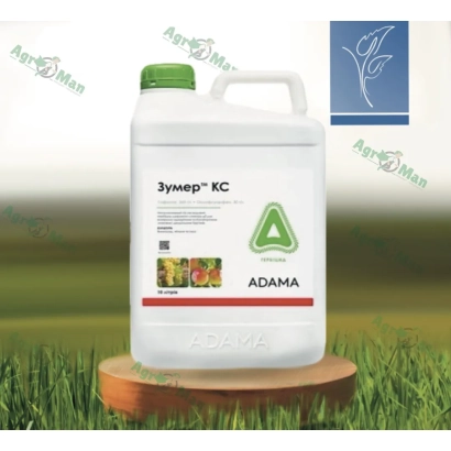 Bottle of herbicide Zumer KS on wooden stand against grass background
