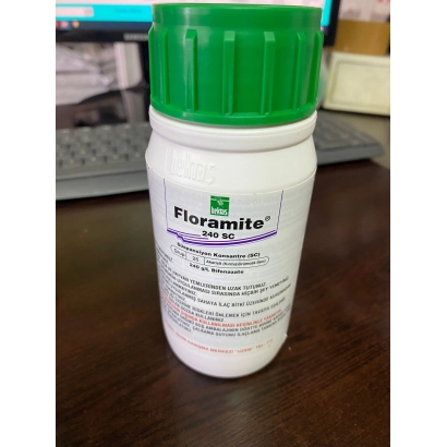 Bottle of insecticide Floramite 240 CS on a wooden surface