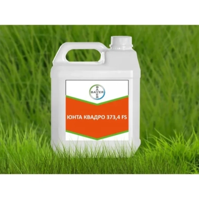 White jug with label Yunta Quadro 373,4 FS on green grass background
