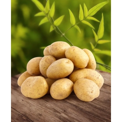 A pile of potatoes on a wooden surface with green leaves in the background. - BANKIR