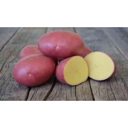 Червоні картоплини на дерев'яній поверхні, одна розрізана навпіл, видно жовту м'якоть. - Лабелла