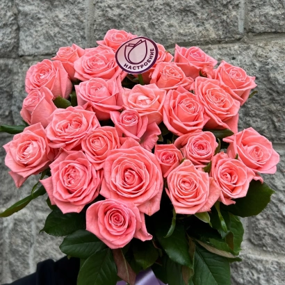 Bouquet of Anna Leningradskaya roses against a stone wall.