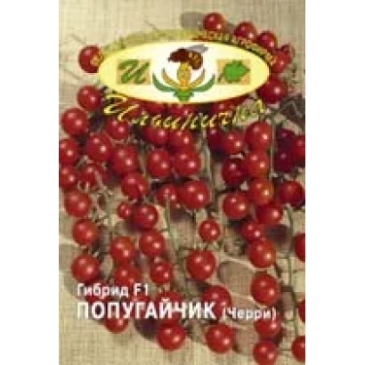 Семена томата ПУПУГАЙЧИК F1 на фоне красных плодов - ПОПУГАЙЧИК F1