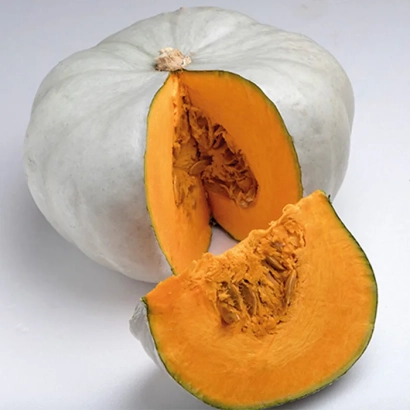 White pumpkin with a cut section showing orange flesh and seeds - Enzo