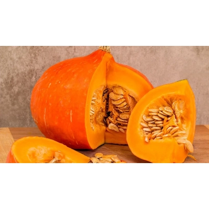 Slice of pumpkin with seeds on wooden surface - Change