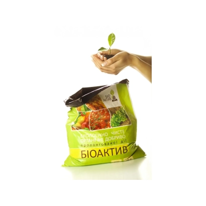 Bag of BioActive fertilizer with vegetables and a hand holding a sprout